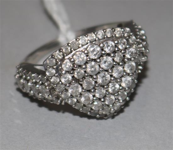 A 9ct white gold and pave set diamond shield shape ring, with diamond set shoulders, size P/Q.